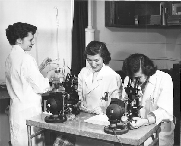 Researchers with microscopes in Laboratory of Experimental Oncology